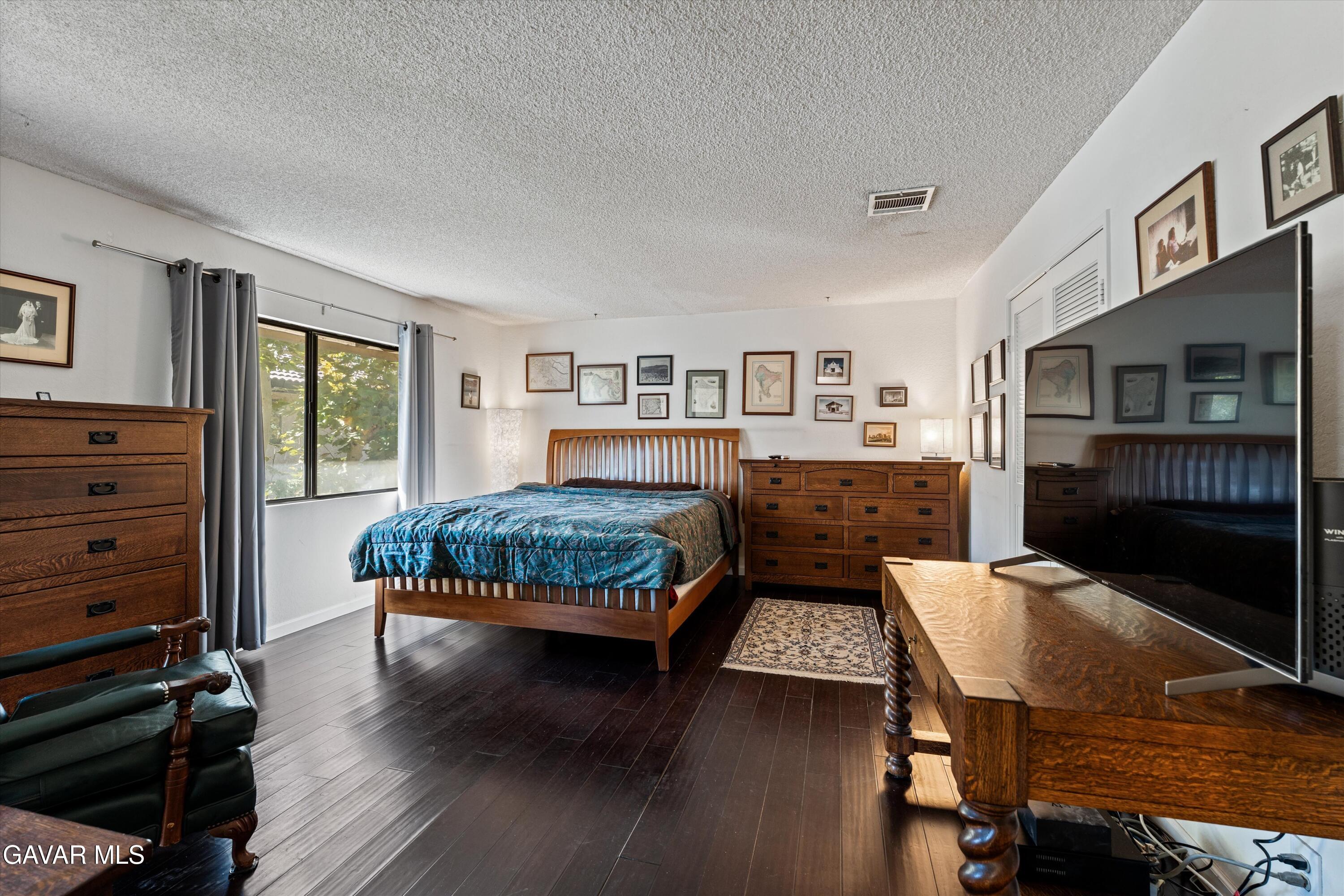 236 Hawk Lane Palmdale, CA 93551 - Photo 13 of 23 a bedroom with a bed and wooden floor