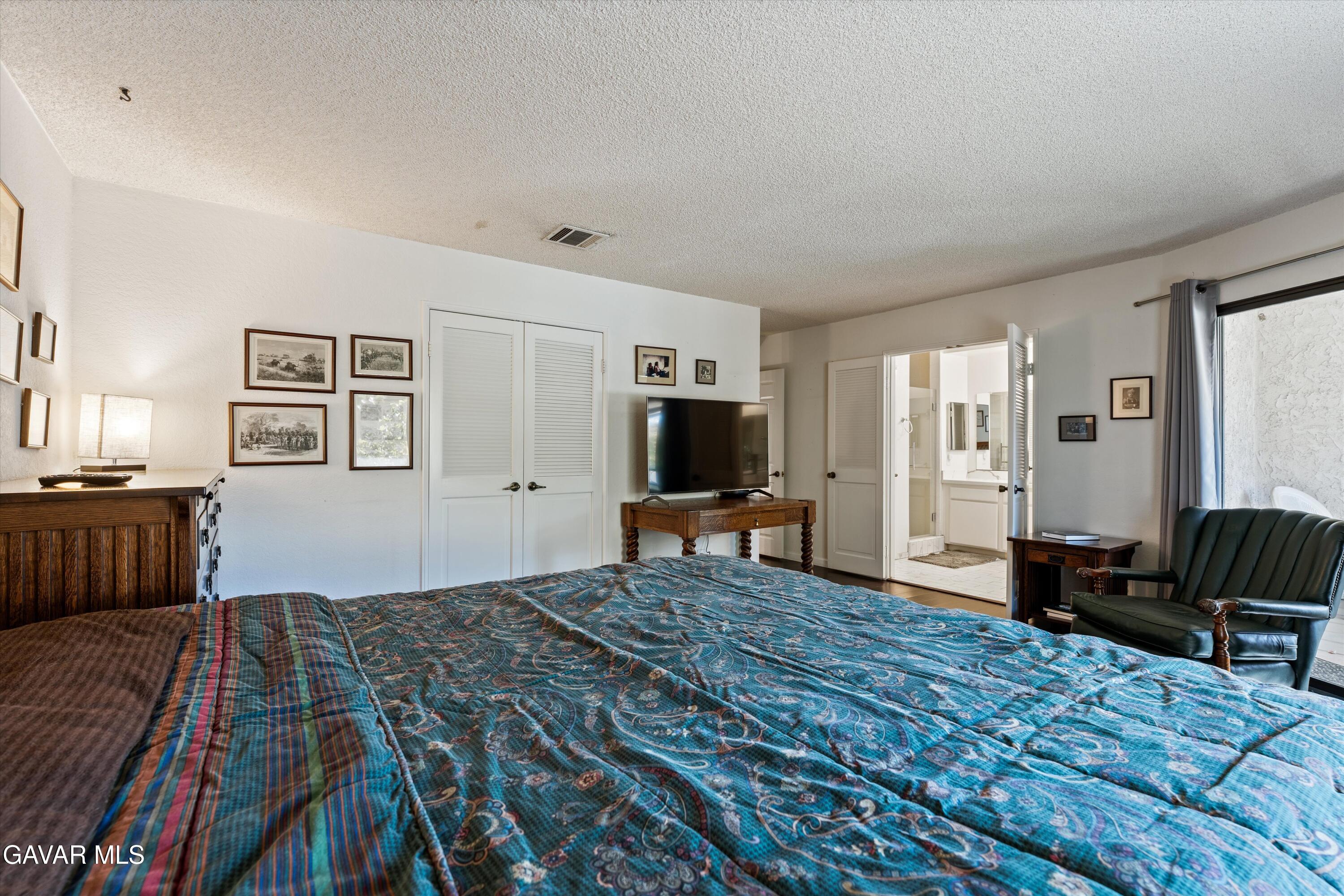 236 Hawk Lane Palmdale, CA 93551 - Photo 14 of 23 a bedroom with furniture and a flat screen tv