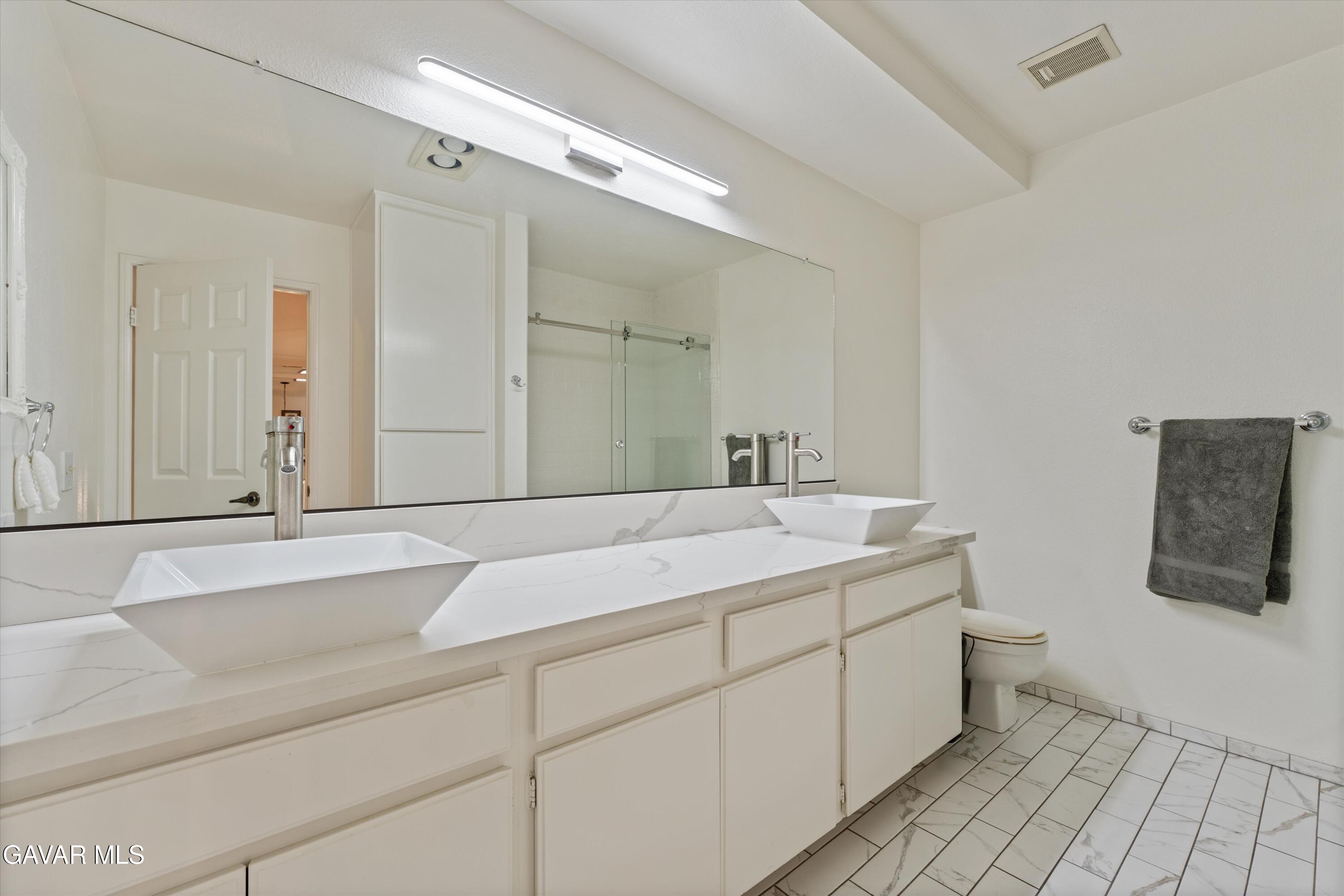 236 Hawk Lane Palmdale, CA 93551 - Photo 17 of 23 a bathroom with a sink and a mirror