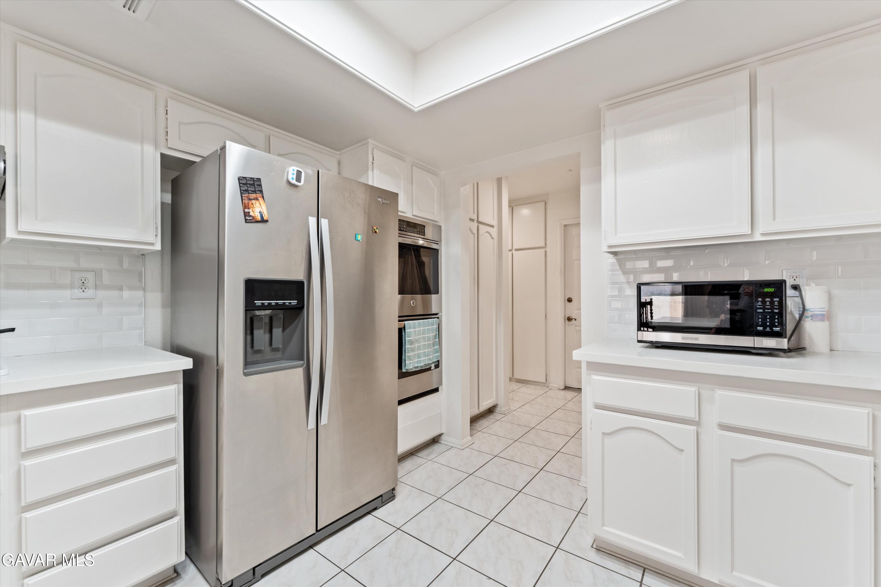 236 Hawk Lane Palmdale, CA 93551 - Photo 8 of 23 a kitchen with stainless steel appliances a refrigerator and a stove top oven