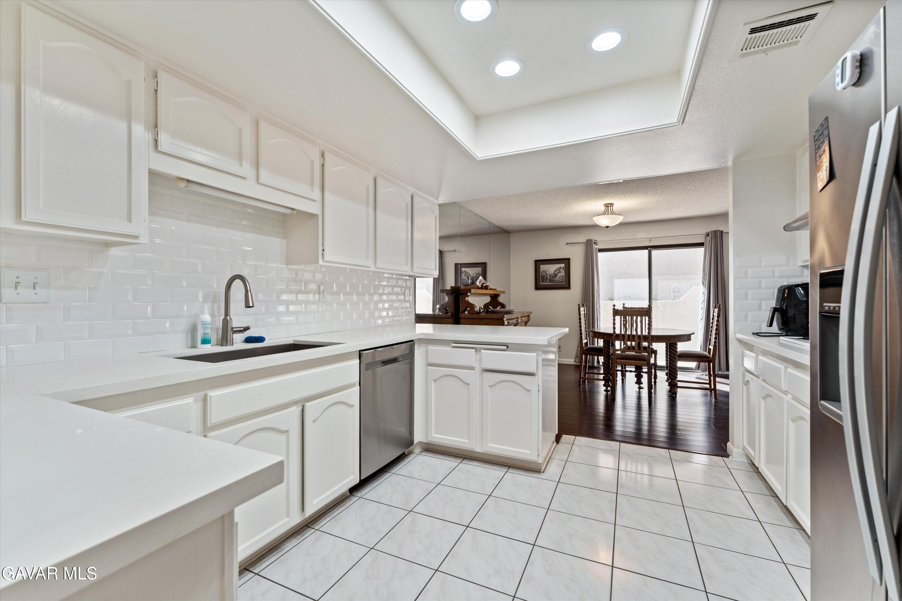 236 Hawk Lane Palmdale, CA 93551 - Photo 9 of 23 a kitchen with a sink window and cabinets