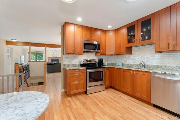 a kitchen with stainless steel appliances granite countertop a stove top oven a sink dishwasher and granite countertops with cabinets