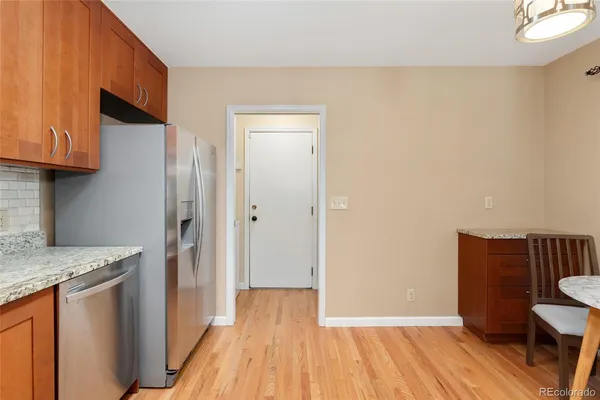 a view of a kitchen with wooden floor and a sink