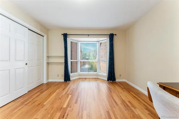 a view of a room with wooden floor and a window