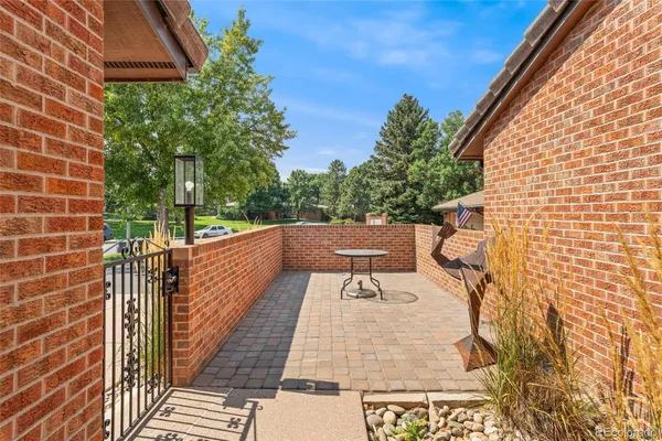 a view of a balcony with wooden floor and fence
