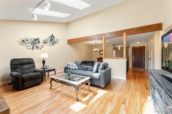 a living room with furniture and a wooden floor