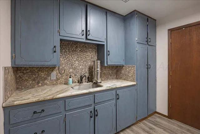 a sink with wooden cabinets