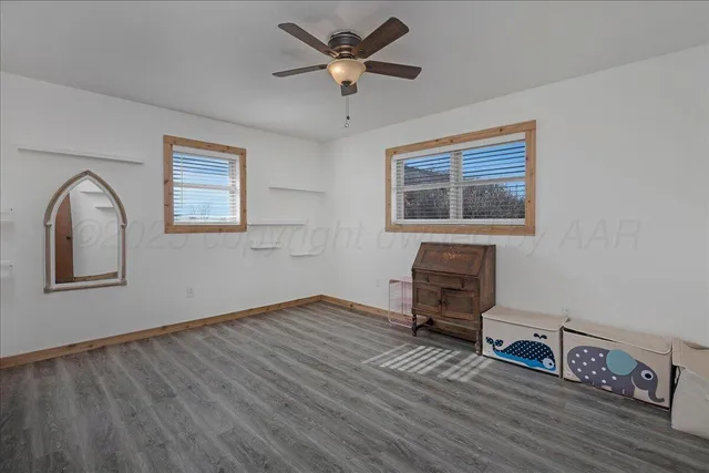 a view of livingroom with hardwood floor and a ceiling fan