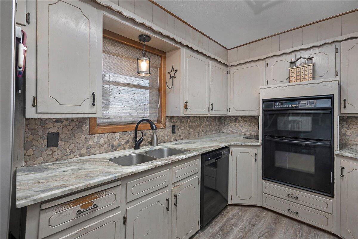 39000 Farm To Market 1705 Happy, TX 79042 - Photo 8 of 45 a kitchen with stainless steel appliances granite countertop a sink and cabinets with wooden floor