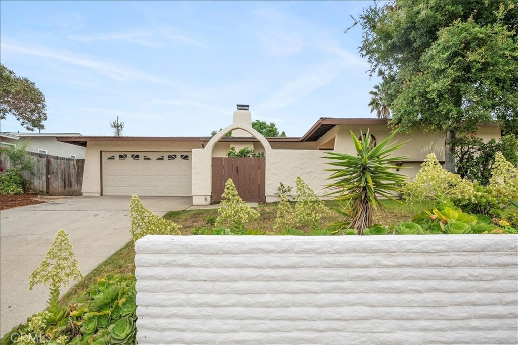 4001 Pala Road Oceanside, CA 92057 - Photo 1 of 1 a front view of a house with a yard and garage