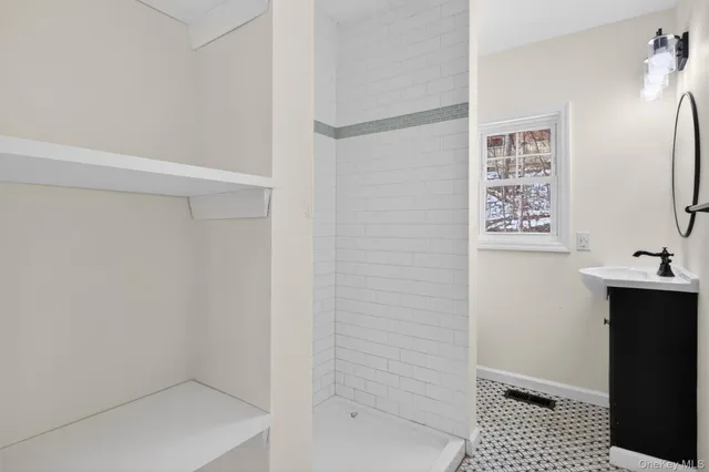 a bathroom with a sink mirror and toilet