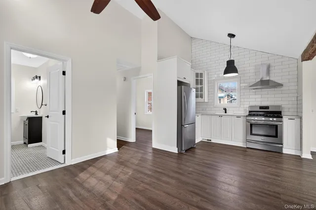 a view of kitchen with wooden floor electronic appliances and window