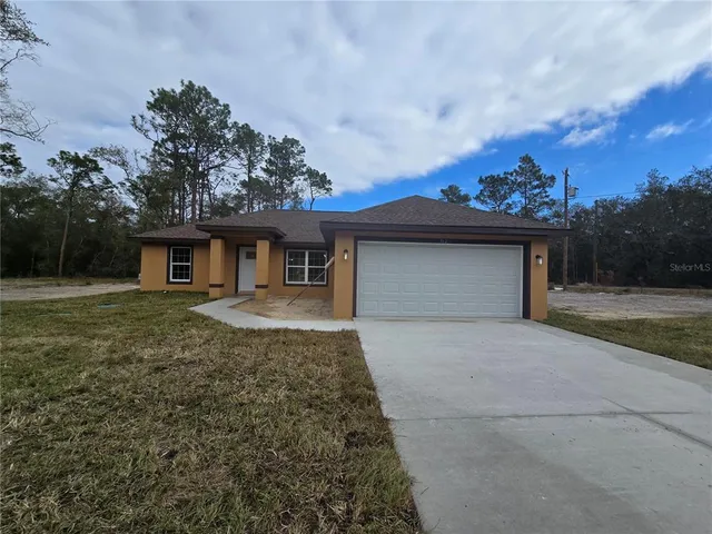 a kitchen with white cabinets appliances and a window