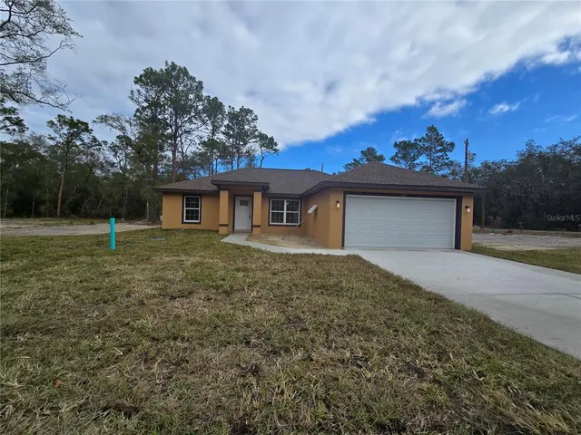 a big house with a big yard and large trees