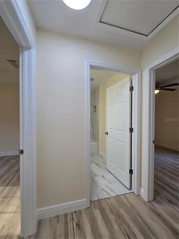 a view of a room with kitchen and center island wooden floor