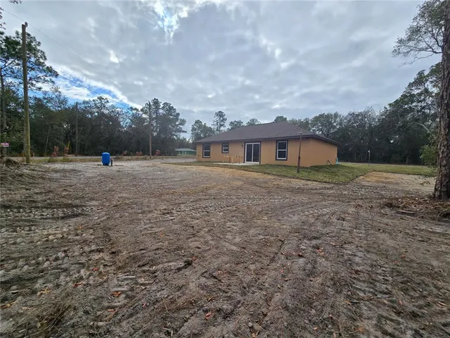 a backyard of a house with lots of green space