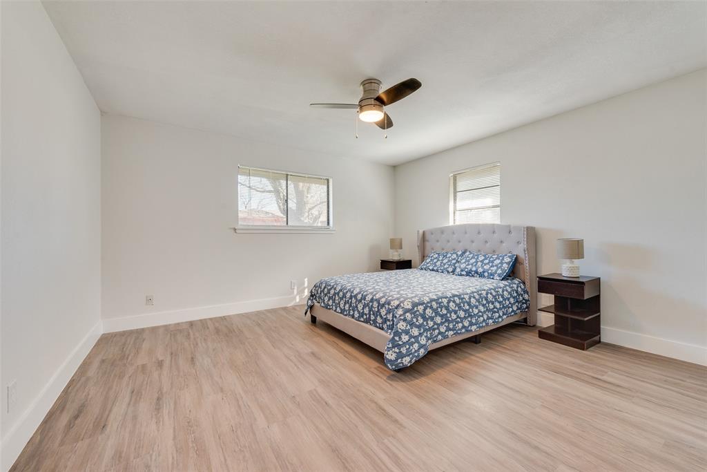 5311 Rocky Ridge Road Dallas, TX 75241 - Photo 17 of 24 a spacious bedroom with a bed and a window