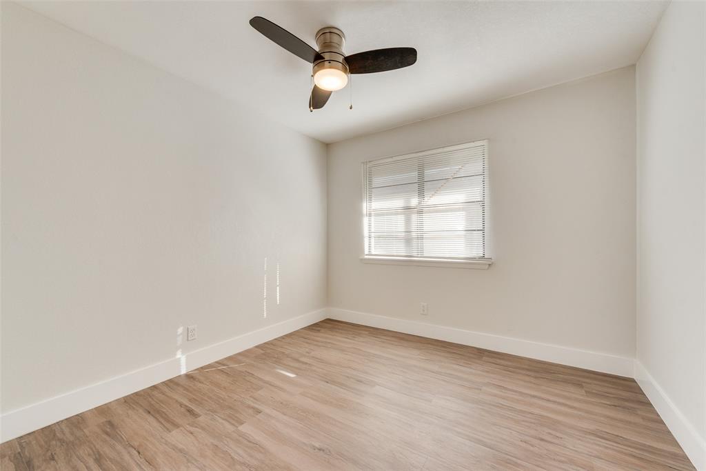 5311 Rocky Ridge Road Dallas, TX 75241 - Photo 20 of 24 an empty room with wooden floor ceiling fan and windows
