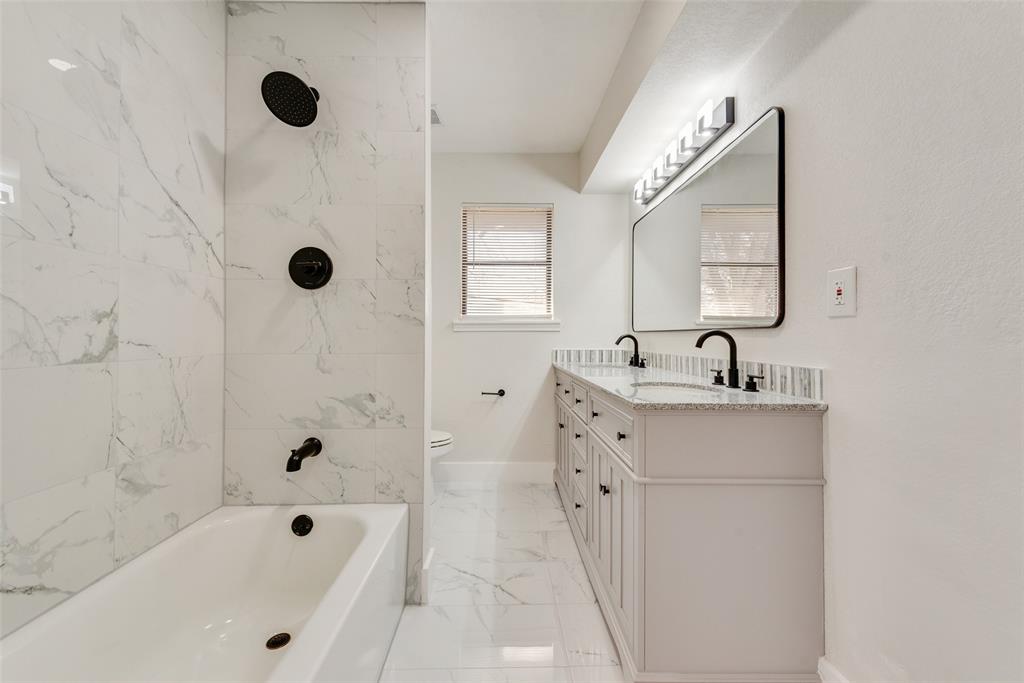 5311 Rocky Ridge Road Dallas, TX 75241 - Photo 22 of 24 a bathroom with a tub sink a mirror and shower