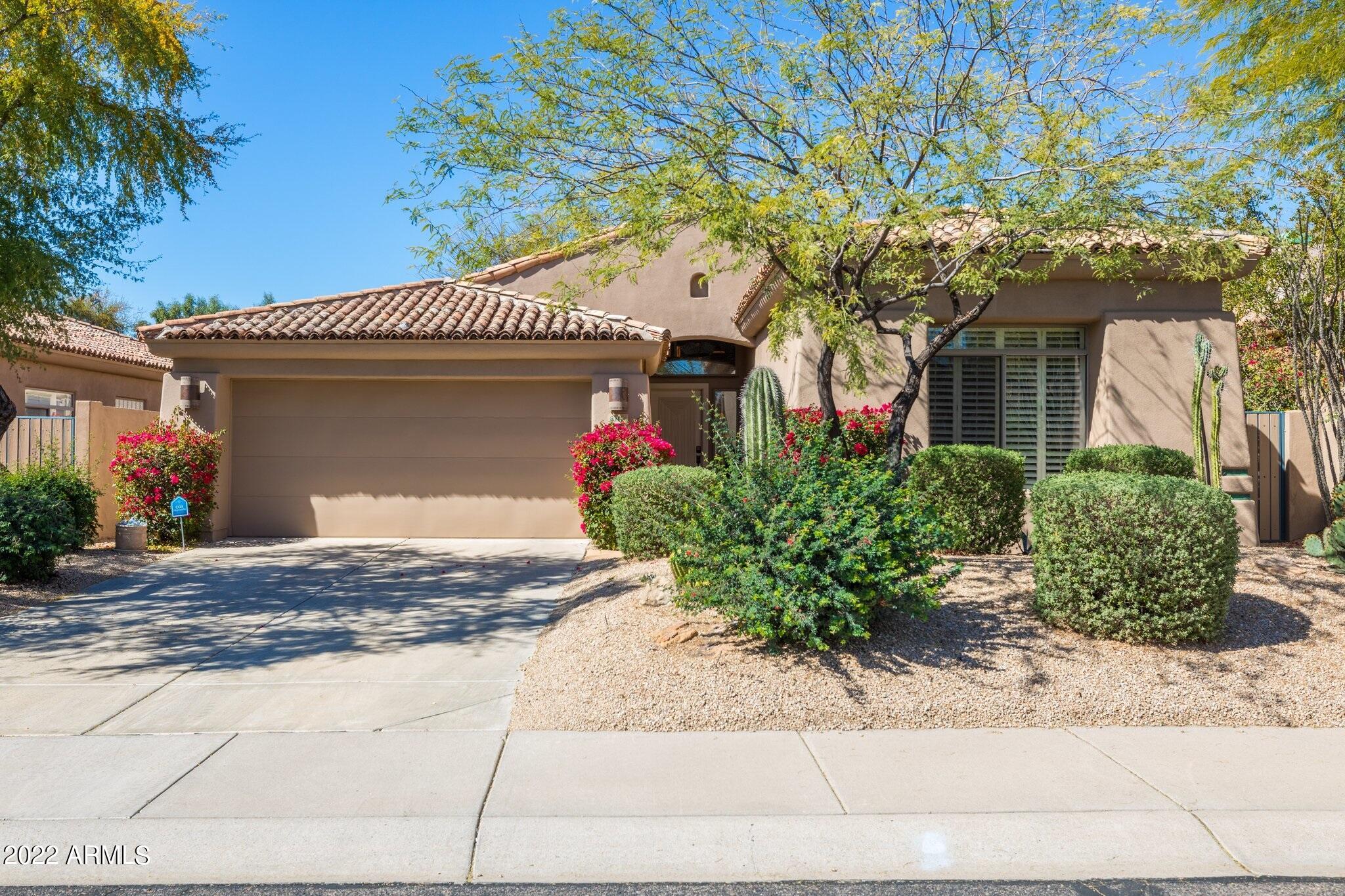 8184 East Beardsley Road Scottsdale, AZ 85255 - Photo 1 of 39 a front view of a house with garden