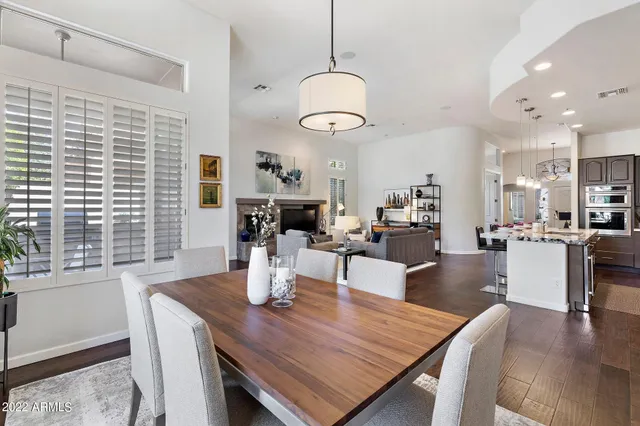 a living room with dining table and a large window