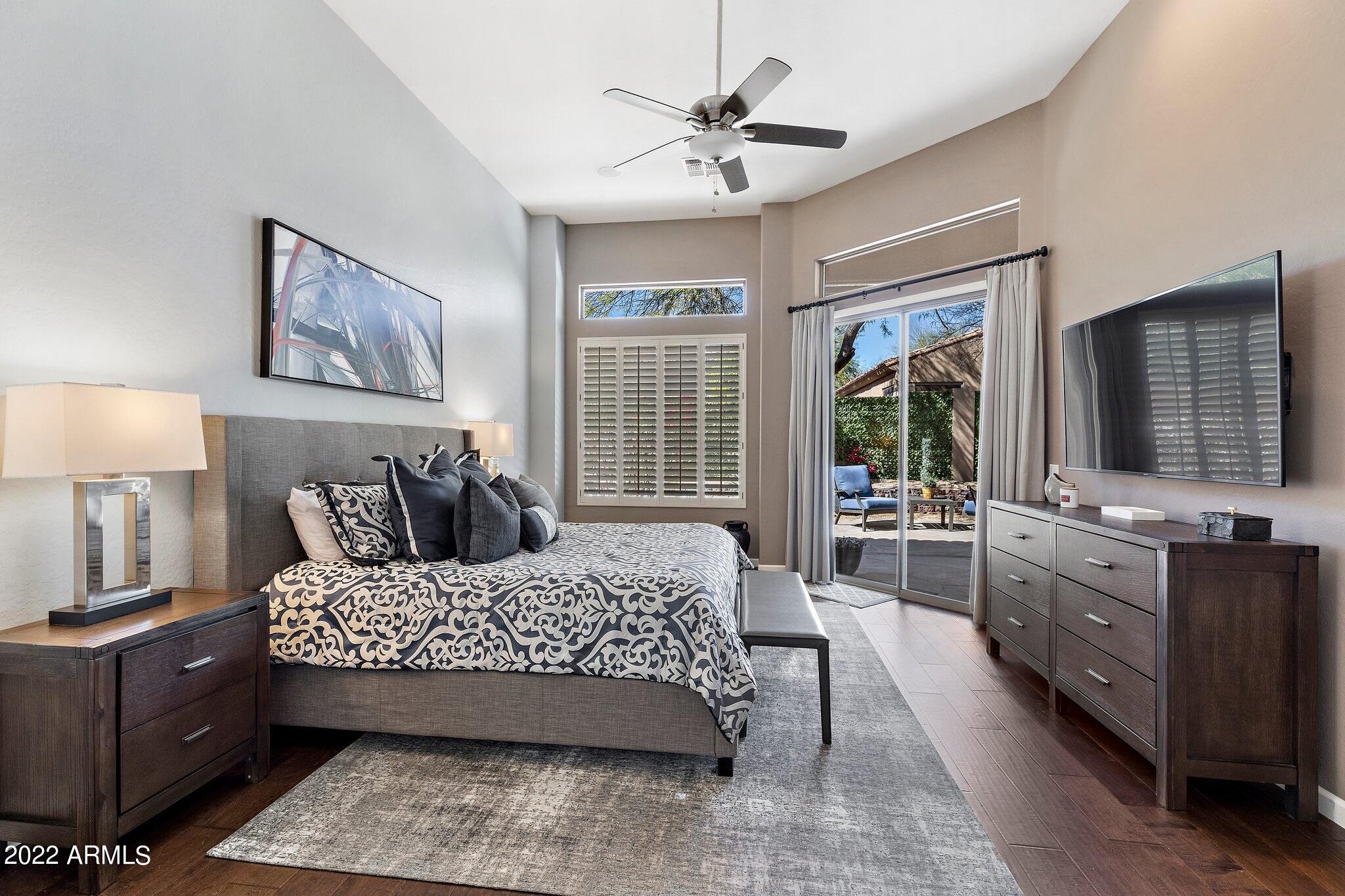 8184 East Beardsley Road Scottsdale, AZ 85255 - Photo 15 of 39 a bedroom with a large bed and a flat tv screen on dresser