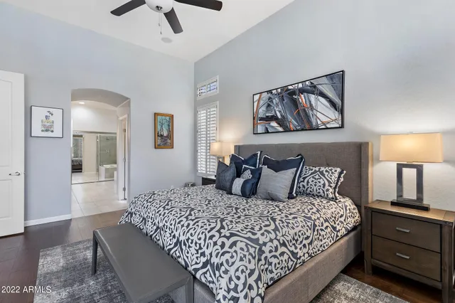 a large bedroom with a bed and wooden floor