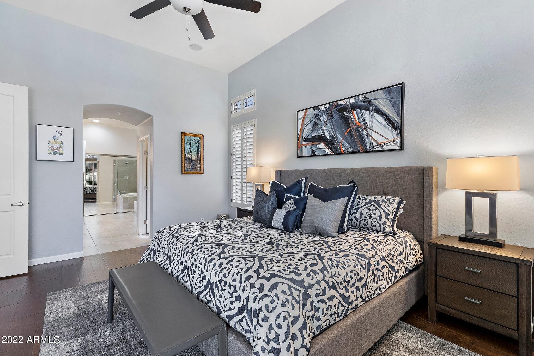 8184 East Beardsley Road Scottsdale, AZ 85255 - Photo 16 of 39 a large bedroom with a bed and wooden floor