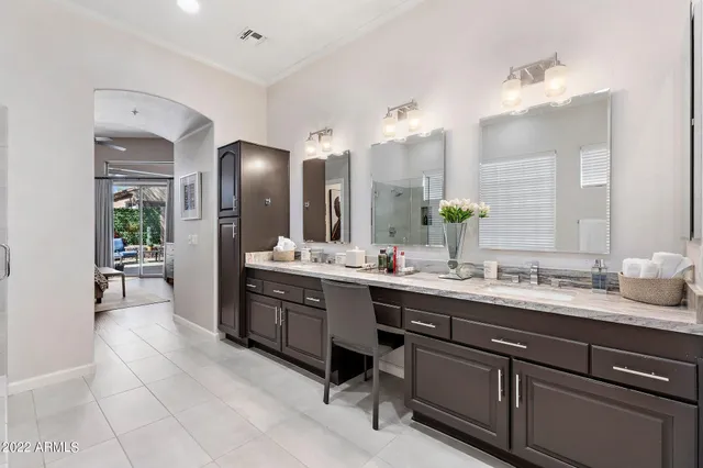 a large bathroom with a double vanity sink a mirror and a shower
