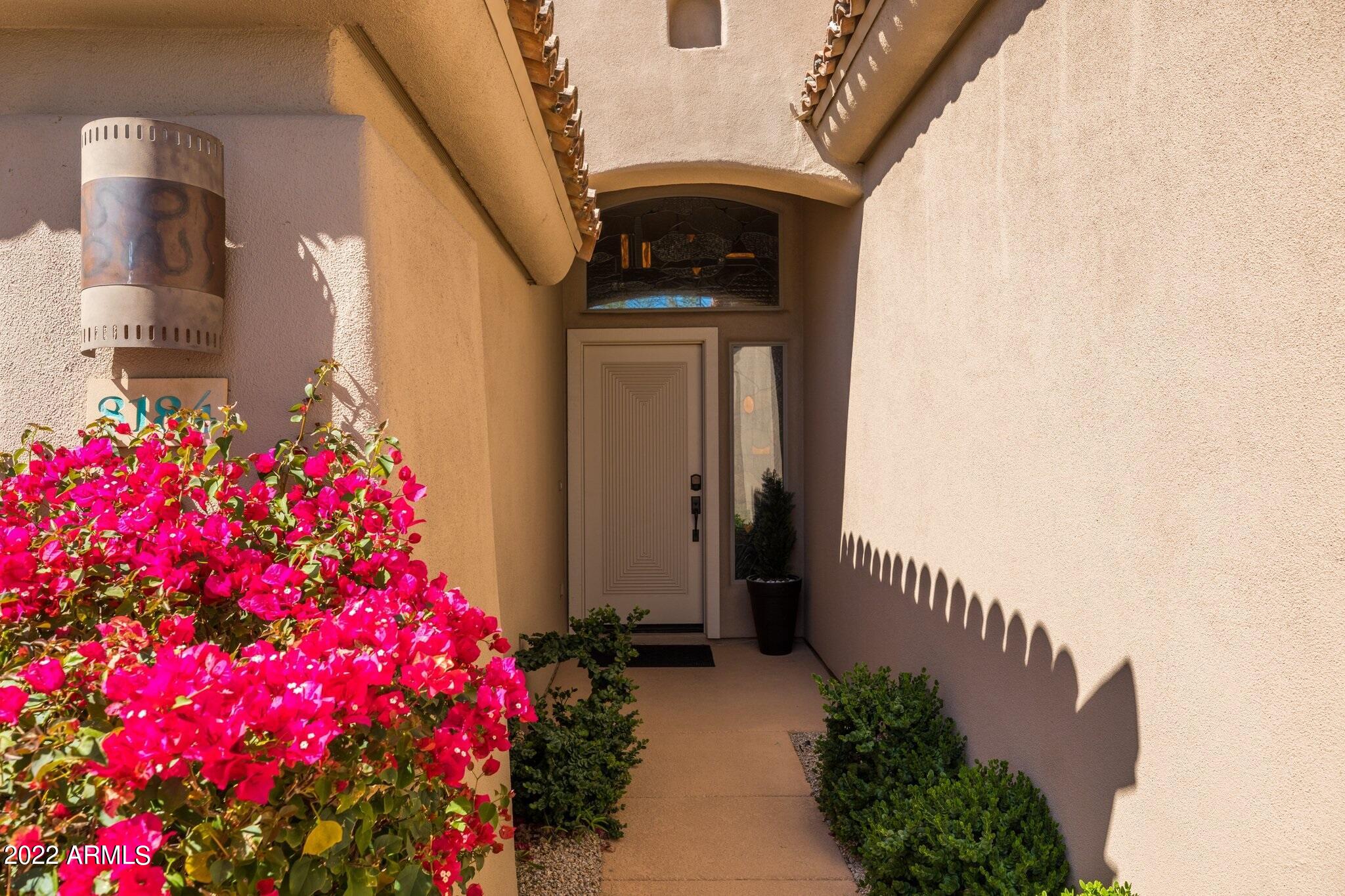 8184 East Beardsley Road Scottsdale, AZ 85255 - Photo 2 of 39 a flower plants in front of a door