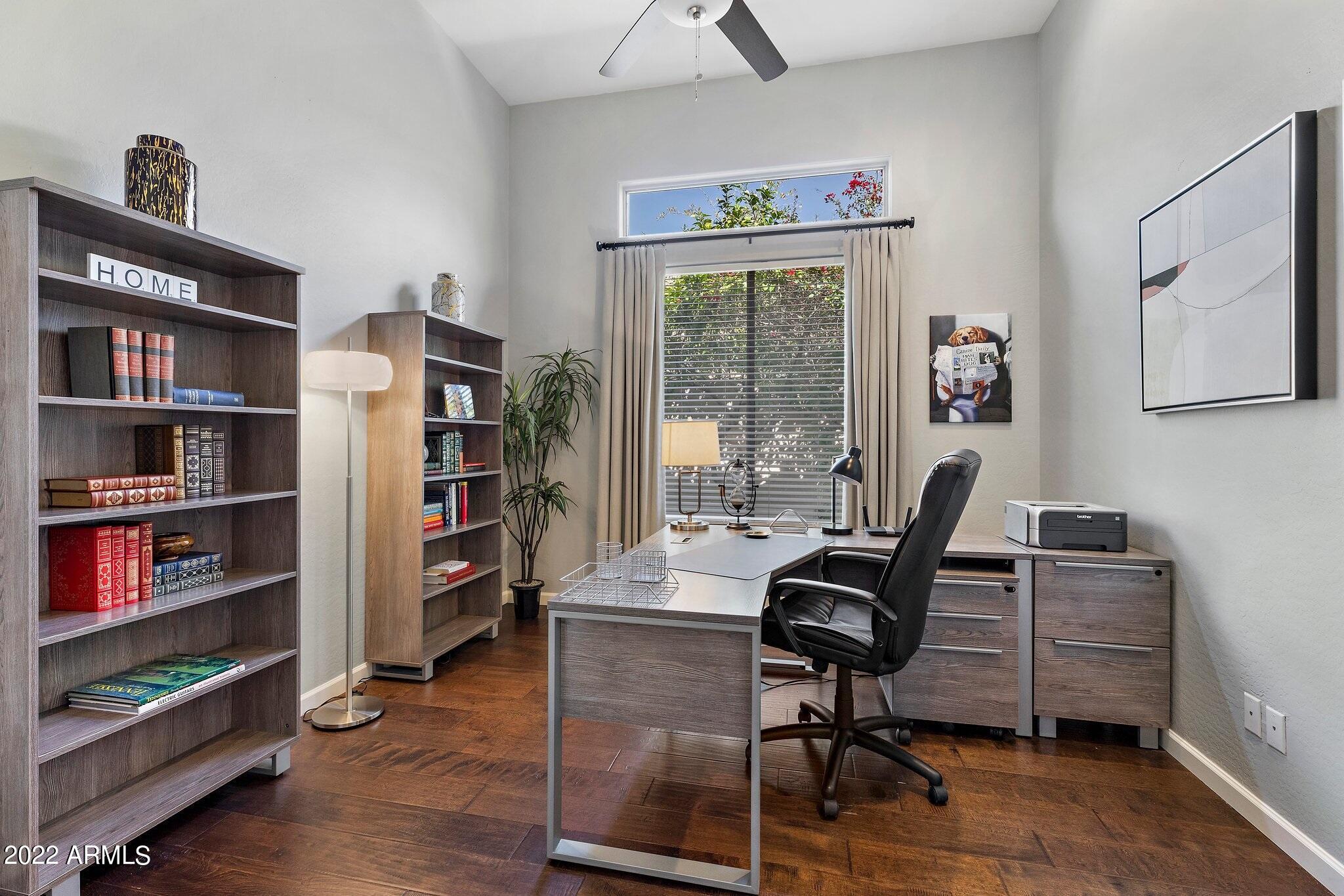 8184 East Beardsley Road Scottsdale, AZ 85255 - Photo 21 of 39 a view of a workspace with furniture and a bookshelf
