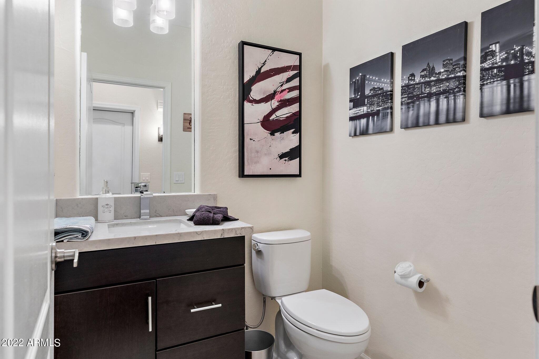 8184 East Beardsley Road Scottsdale, AZ 85255 - Photo 22 of 39 a bathroom with a toilet sink and mirror