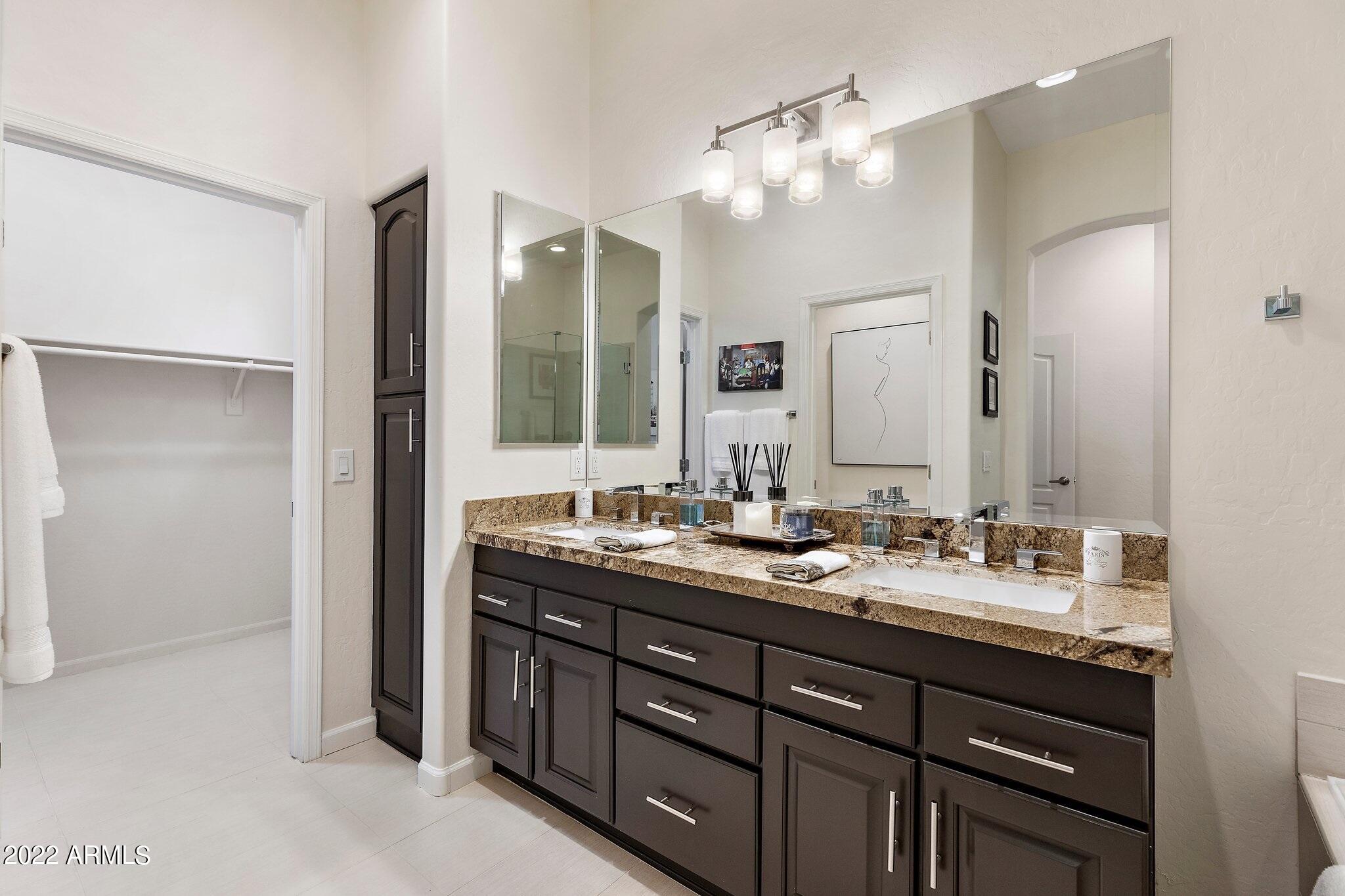 8184 East Beardsley Road Scottsdale, AZ 85255 - Photo 24 of 39 a bathroom with double vanity sinks and a mirror