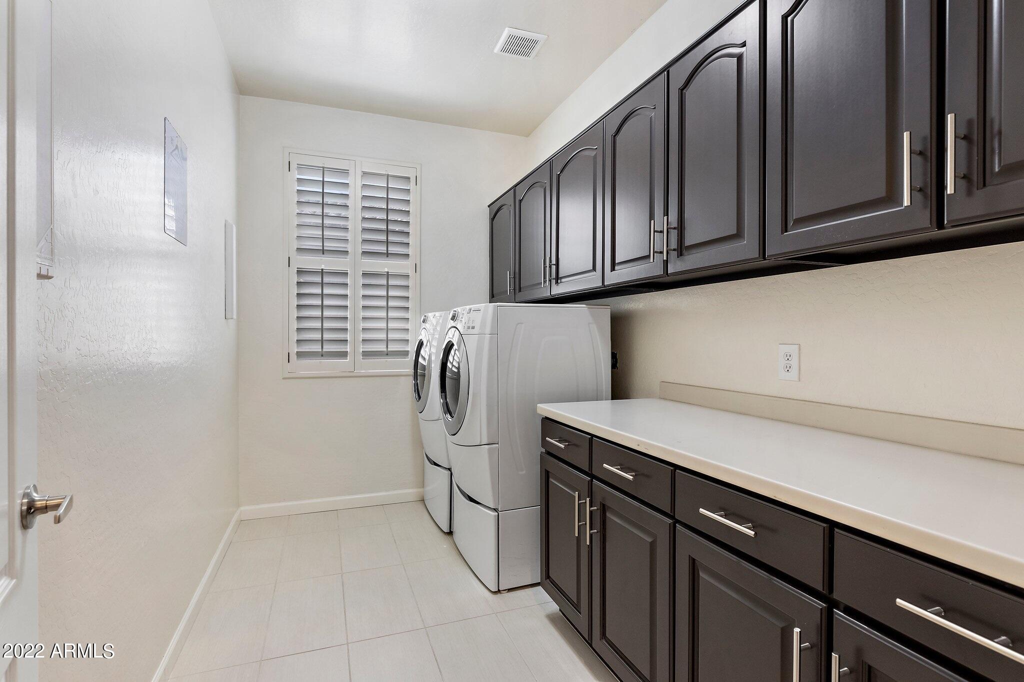 8184 East Beardsley Road Scottsdale, AZ 85255 - Photo 26 of 39 a utility room with cabinets