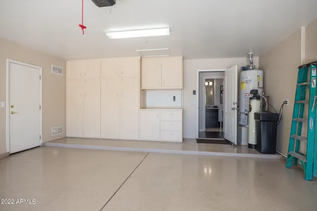 a view of a patio with table and chairs and potted plants