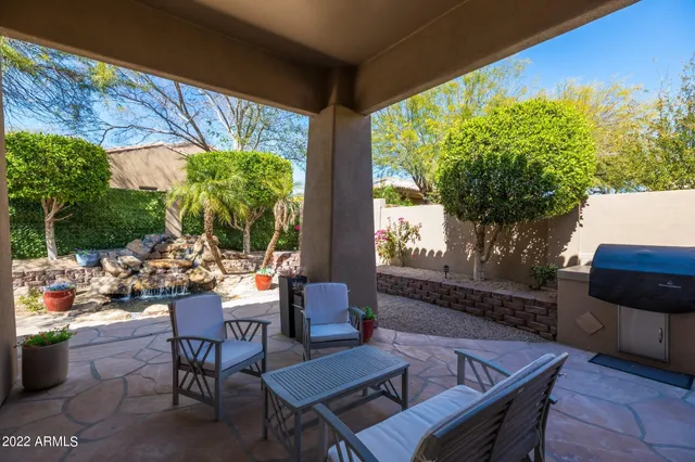 a outdoor space with chairs a couch and a potted plant