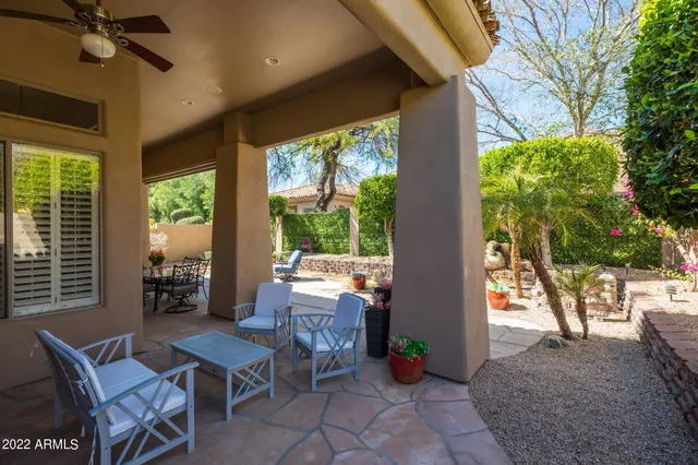 a view of a patio with table and chairs and potted plants