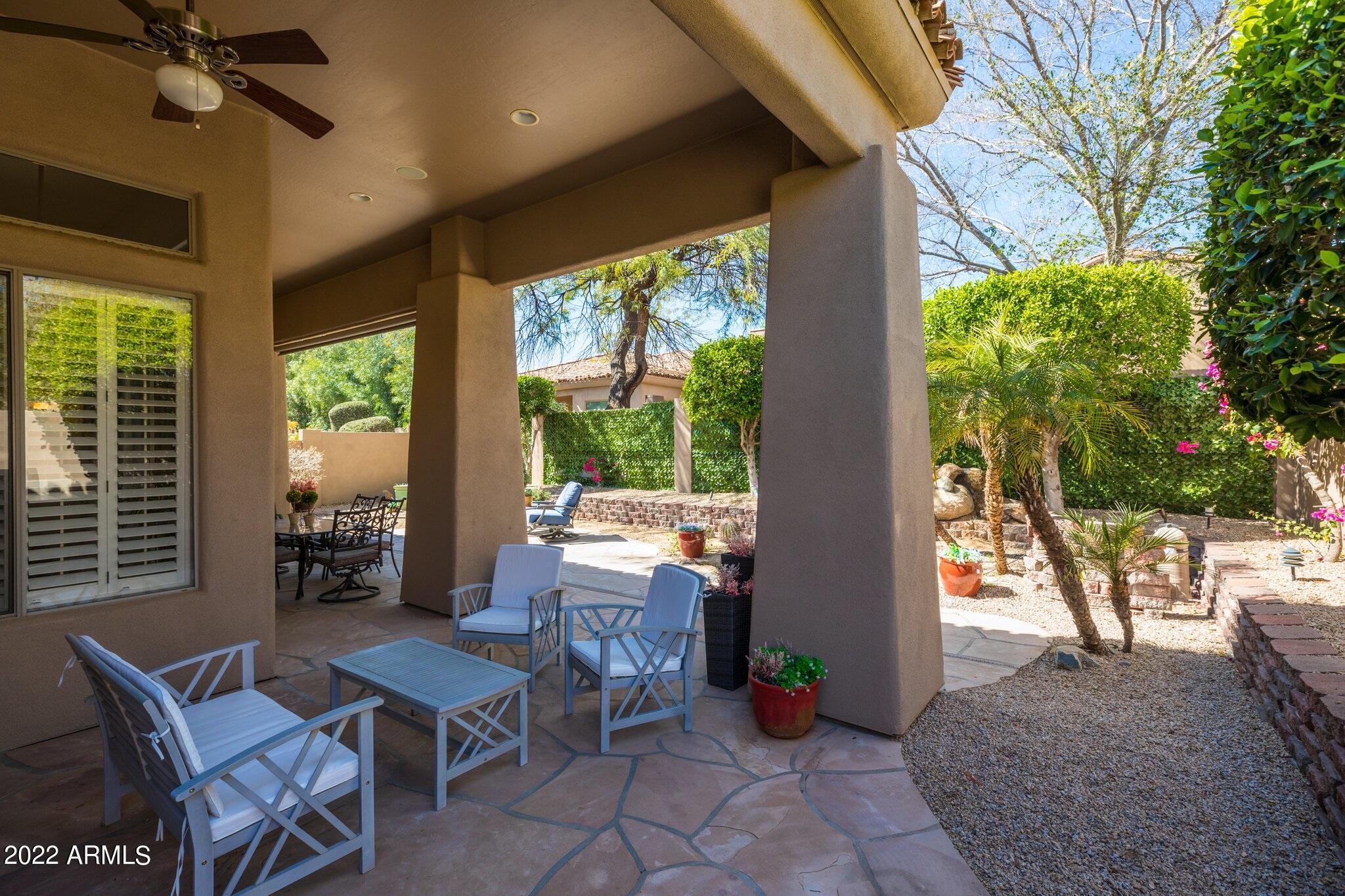 8184 East Beardsley Road Scottsdale, AZ 85255 - Photo 29 of 39 a outdoor space with chairs a couch and a potted plant