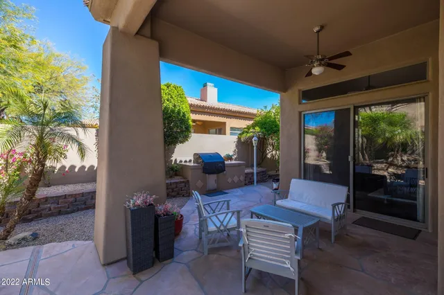 a view of backyard with outdoor seating and trees