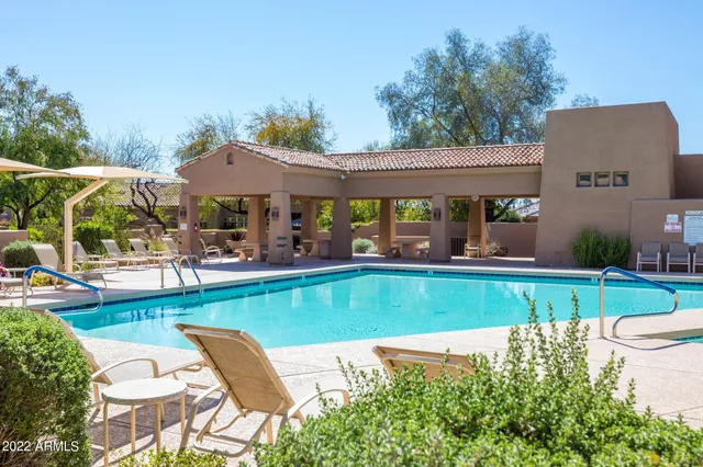 view of a house with a yard and sitting area