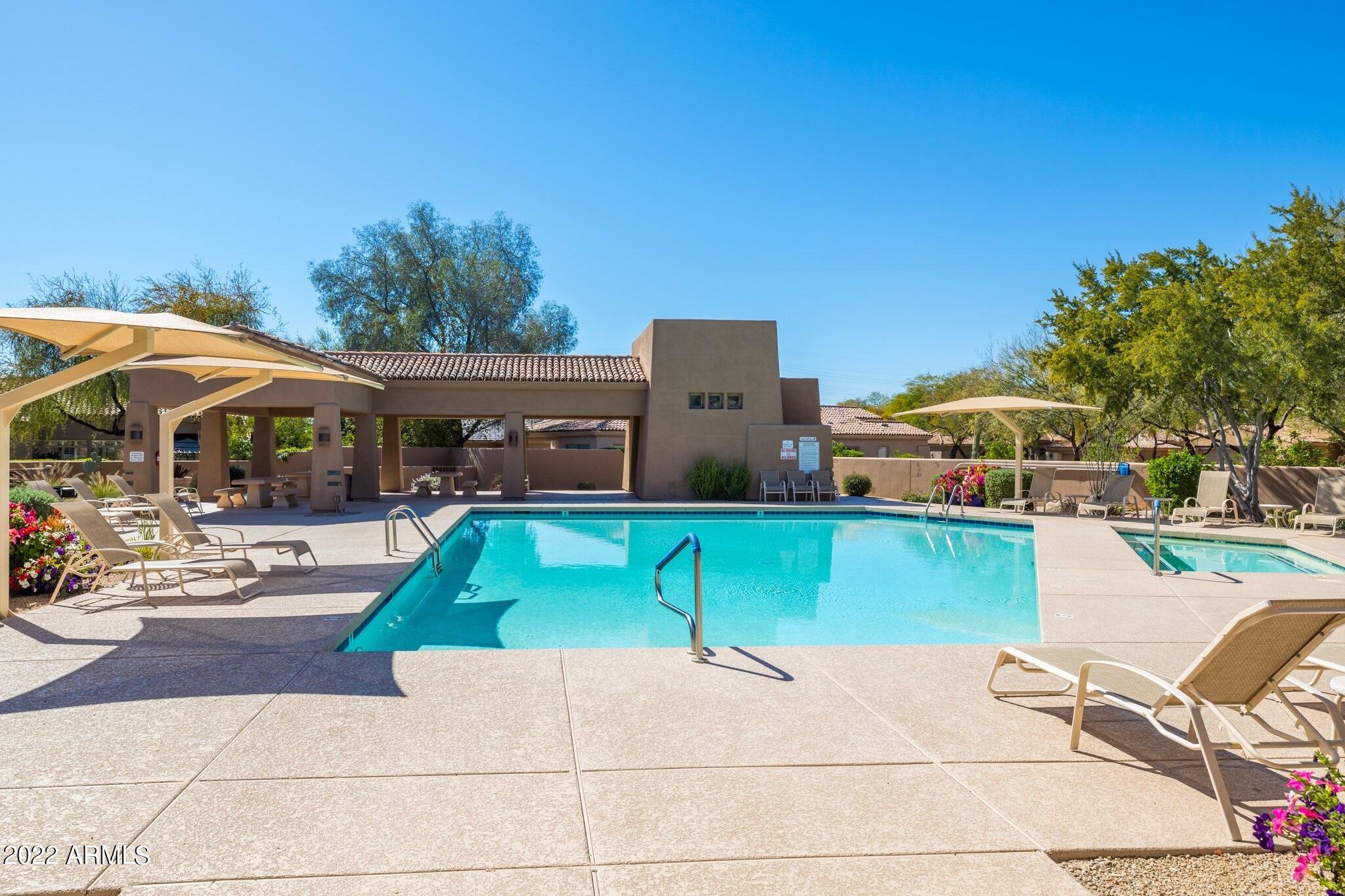 8184 East Beardsley Road Scottsdale, AZ 85255 - Photo 38 of 39 a patio with table and chairs under an umbrella