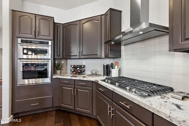 a kitchen with granite countertop cabinets and steel stainless steel appliances