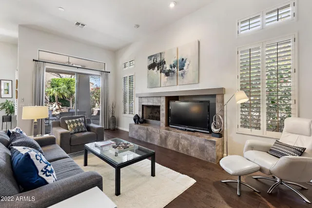 a living room with furniture a rug and a flat screen tv