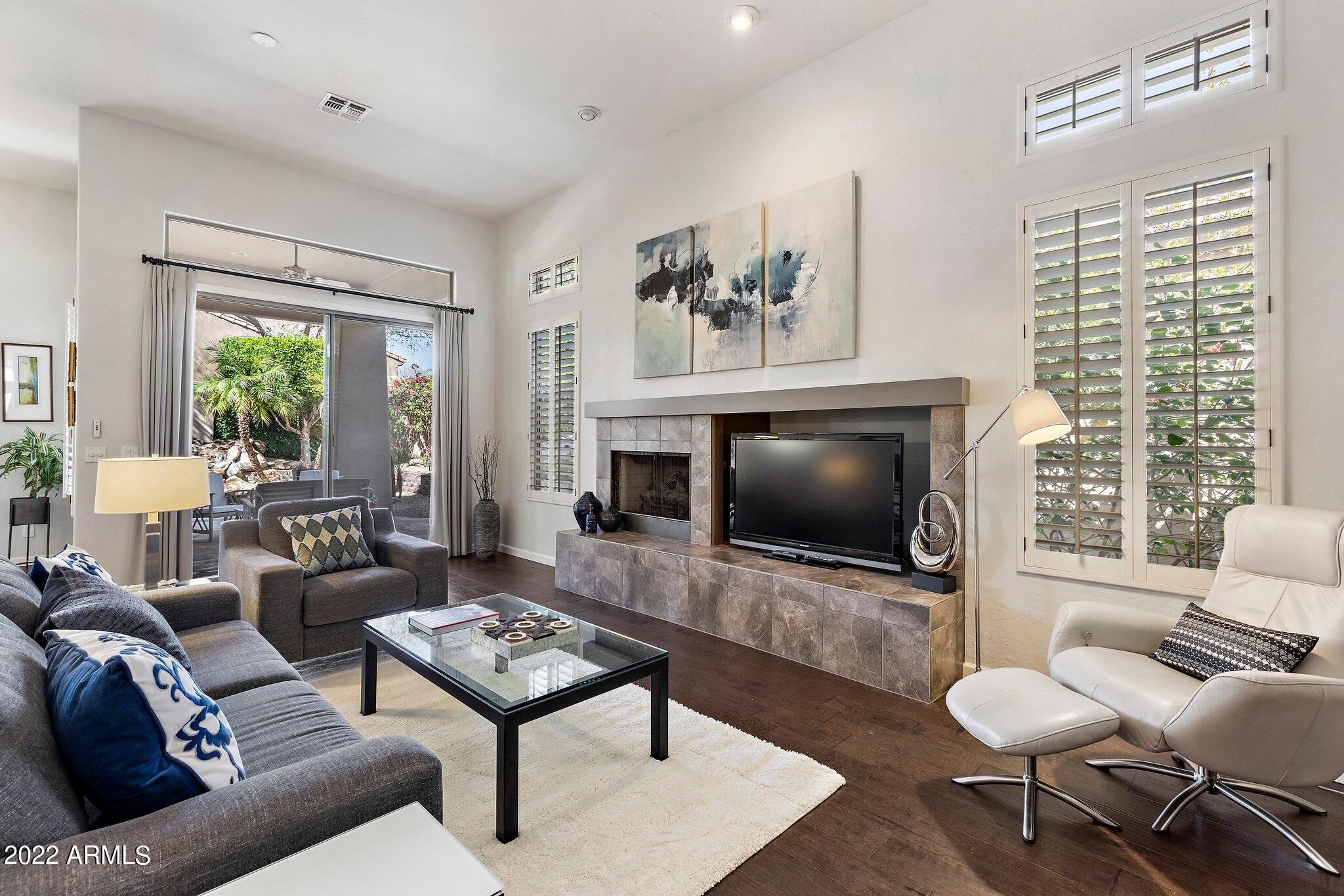 8184 East Beardsley Road Scottsdale, AZ 85255 - Photo 10 of 39 a living room with furniture a rug and a flat screen tv