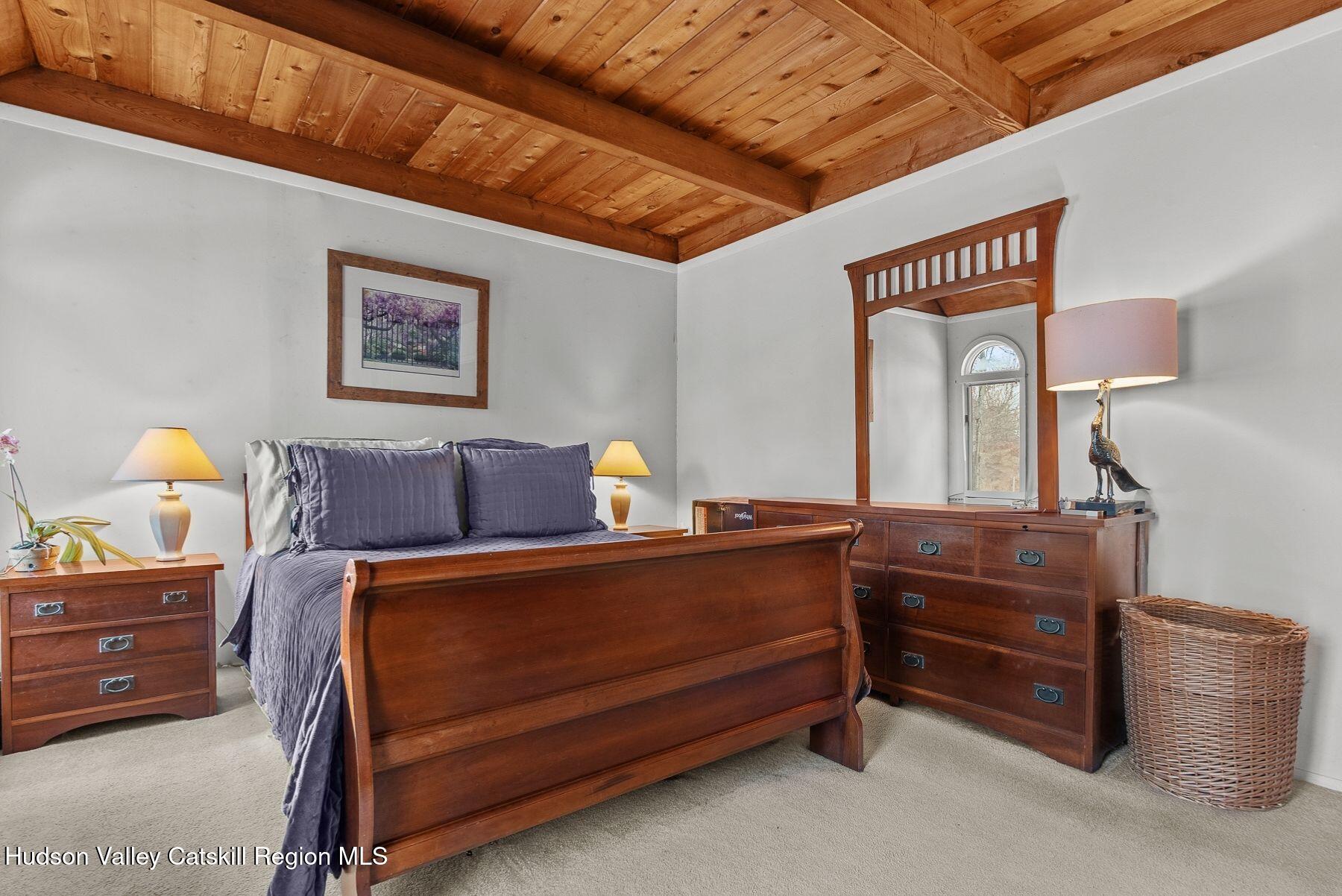 107 Ox Road Roxbury, NY 12421 - Photo 15 of 30 a bed room with a bed and a lamp on dresser