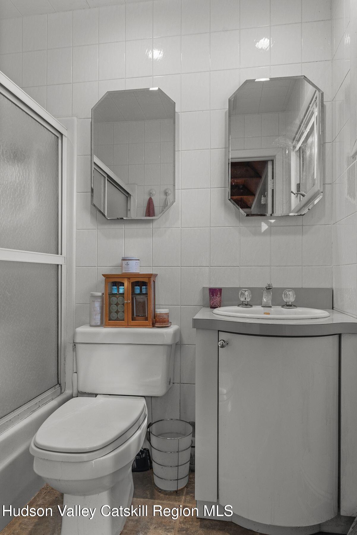 107 Ox Road Roxbury, NY 12421 - Photo 16 of 30 a bathroom with a toilet a sink and mirror