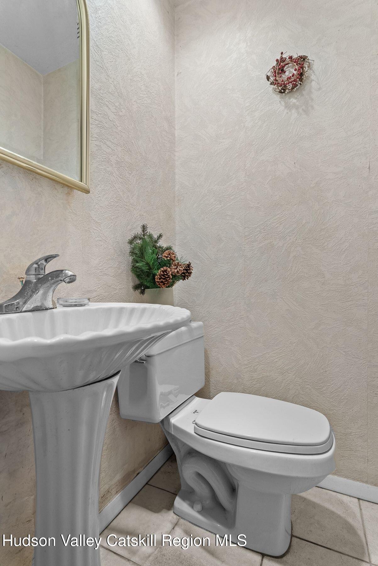 107 Ox Road Roxbury, NY 12421 - Photo 22 of 30 a bathroom with a sink a toilet and mirror