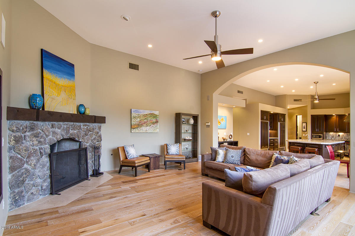 4805 East Pebble Ridge Road Paradise Valley, AZ 85253 - Photo 23 of 37 a living room with furniture and a fireplace