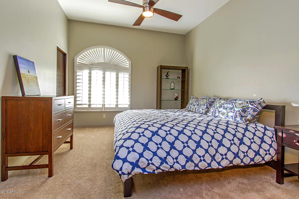 4805 East Pebble Ridge Road Paradise Valley, AZ 85253 - Photo 25 of 37 a bedroom with a bed and window
