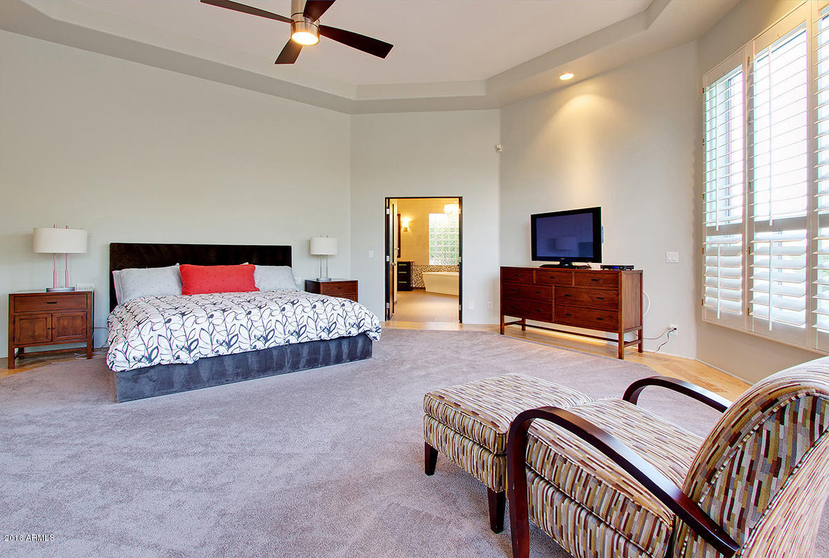 4805 East Pebble Ridge Road Paradise Valley, AZ 85253 - Photo 29 of 37 a bedroom with a bed and a tv